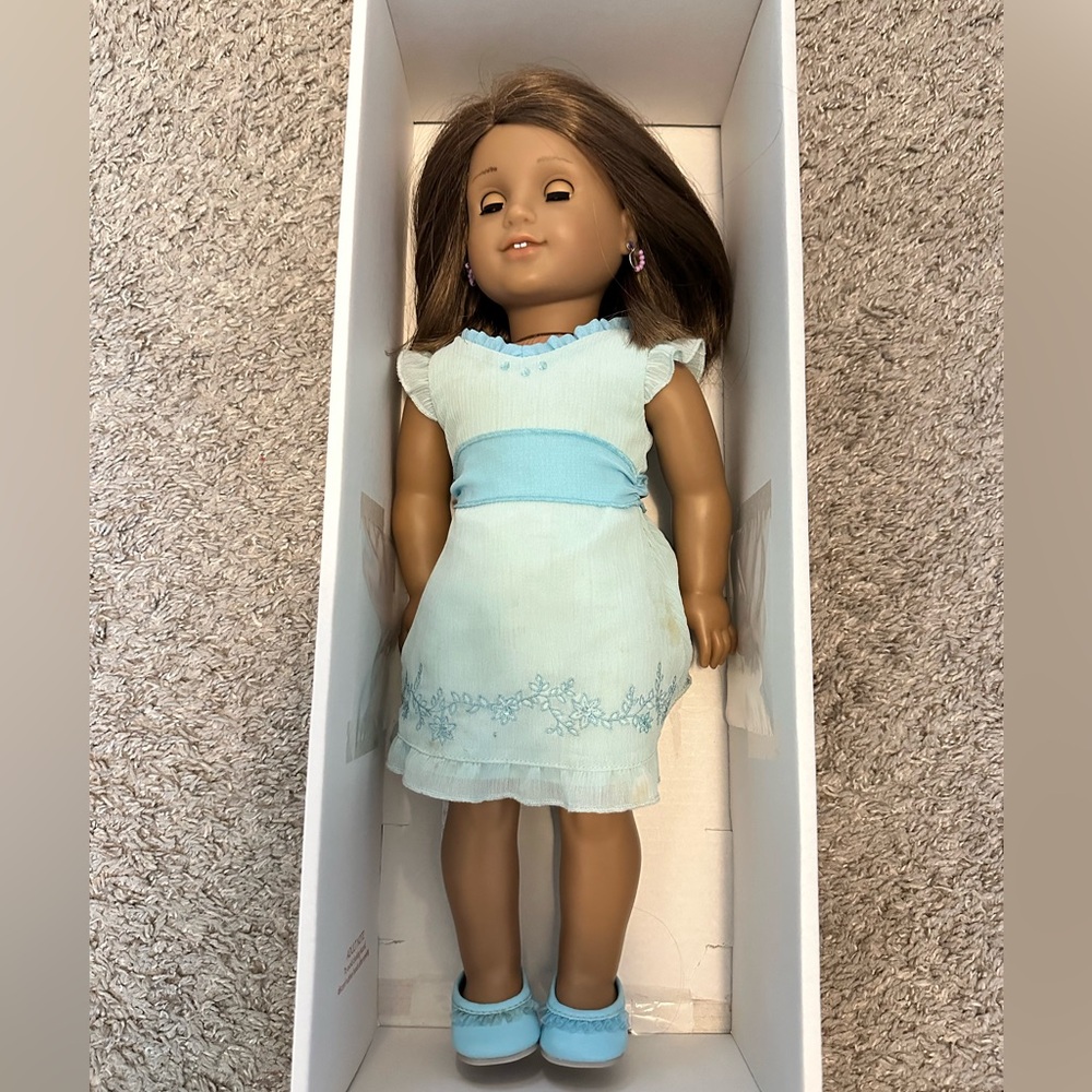 American Girl Doll. Comes with clothes pictures and earrings.